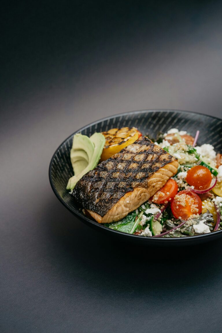 `grilled salmon bowl with avocado quinoa and vegetables for post-run recovery`
