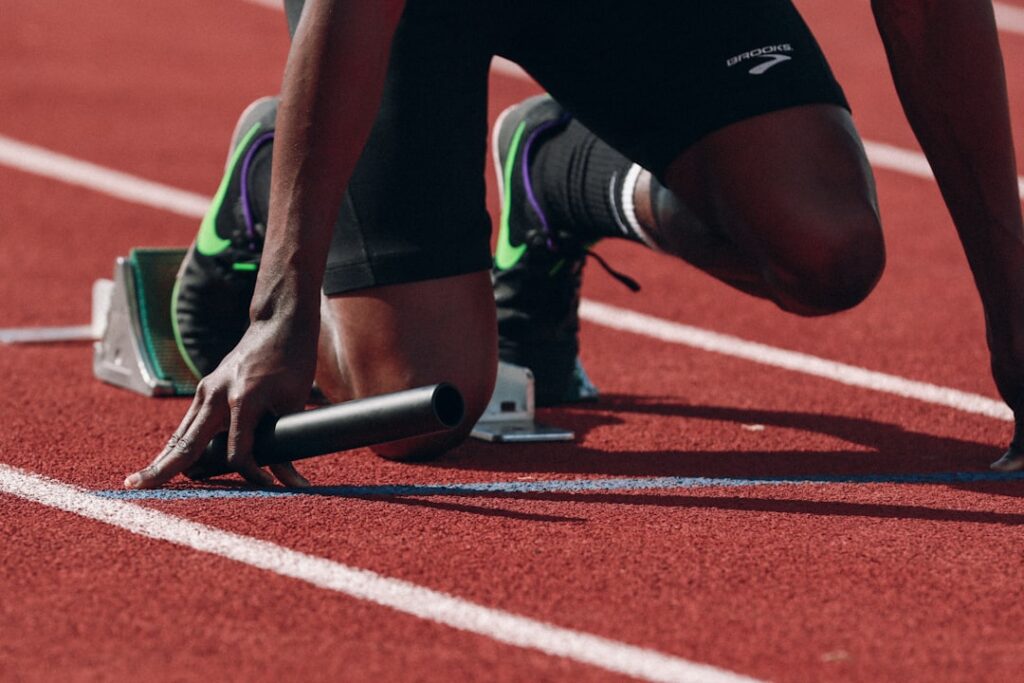 Current image: endurance athlete stretching after a long training run