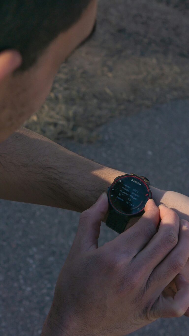 runner looking at GPS watch during outdoor training run