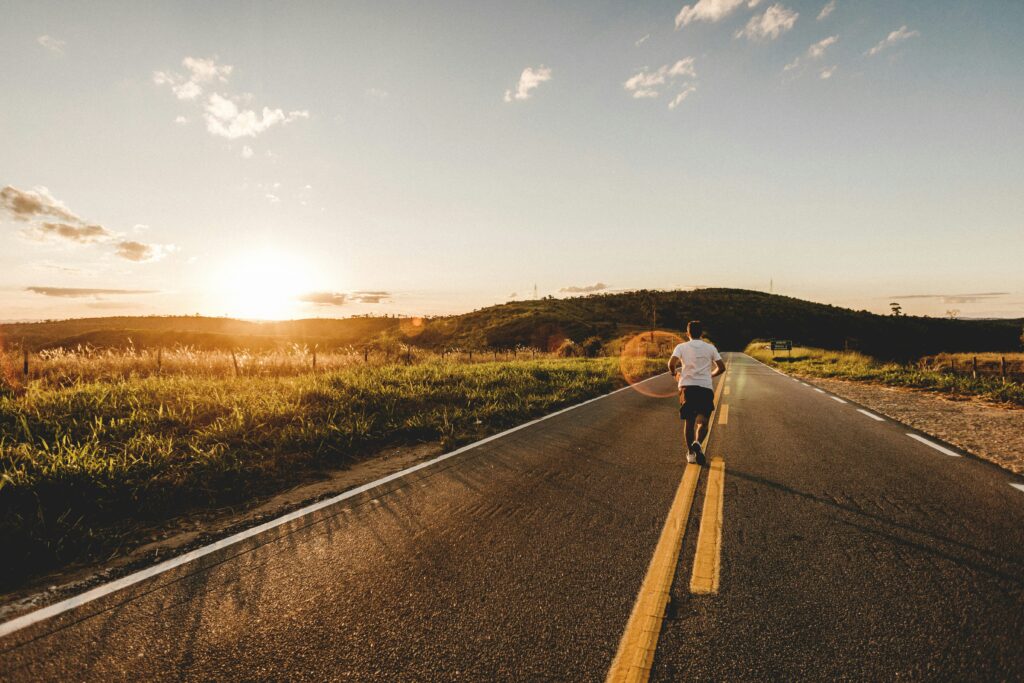 Current image: runner on an open road during an easy morning run at sunrise