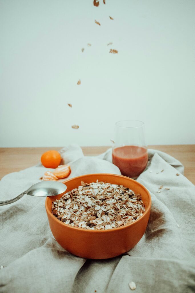 Current image: `muesli bowl with orange and juice as pre-race breakfast for runners`