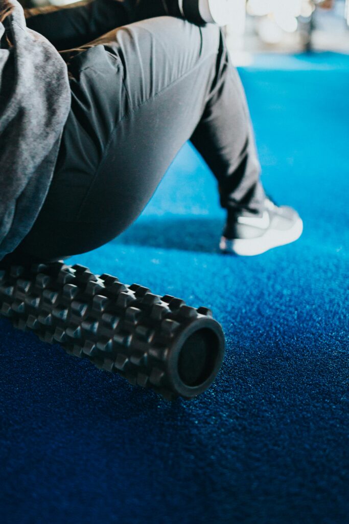 runner using a textured foam roller for post-run muscle recovery