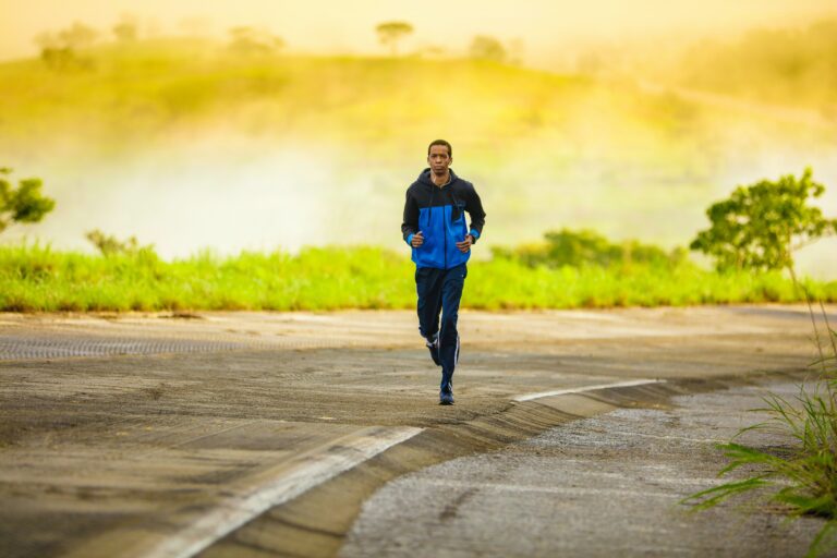 beginner runner training on a road at sunrise