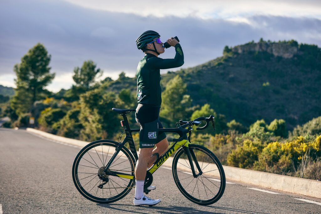 Current image: road cyclist drinking from a bidon on a mountain road